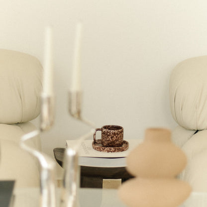 Ceramic mug on a small table with a neutral background